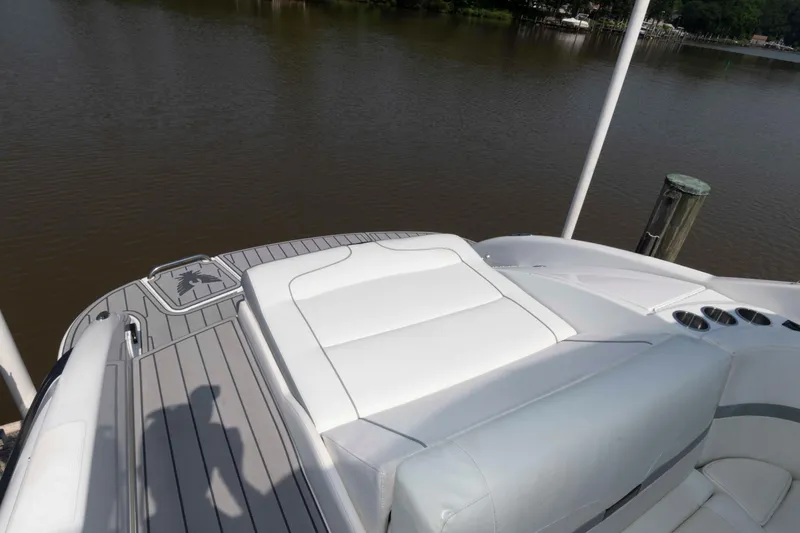 Slide: The Image of 2006 Formula 240 Bowrider boat with white seating, docked by calm water. - 28