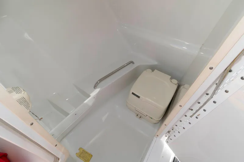 Slide: The Image of 2006 Formula 240 Bowrider boat interior with compact toilet and handrail. - 29
