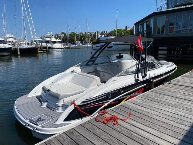 Slide: The Image of 2006 Formula 240 Bowrider docked at marina, featuring sleek design and spacious seating. - 4