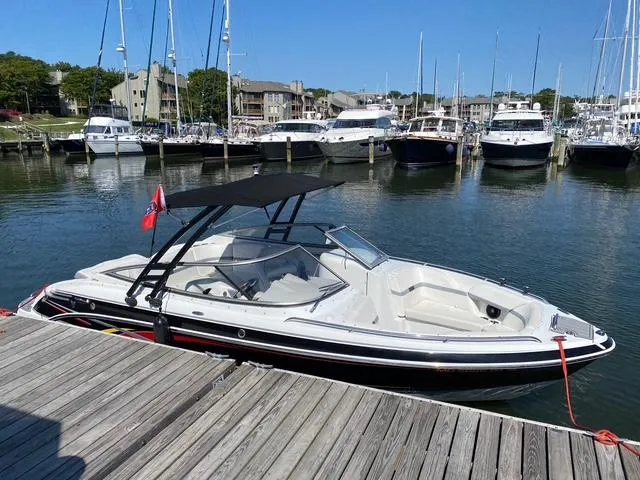 Slide: The Image of 2006 Formula 240 Bowrider docked at a marina with other boats in the background. - 5