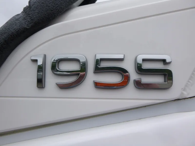 Slide: The Image of Close-up of 2025 Yamaha Boats 195S model emblem on white surface. - 15