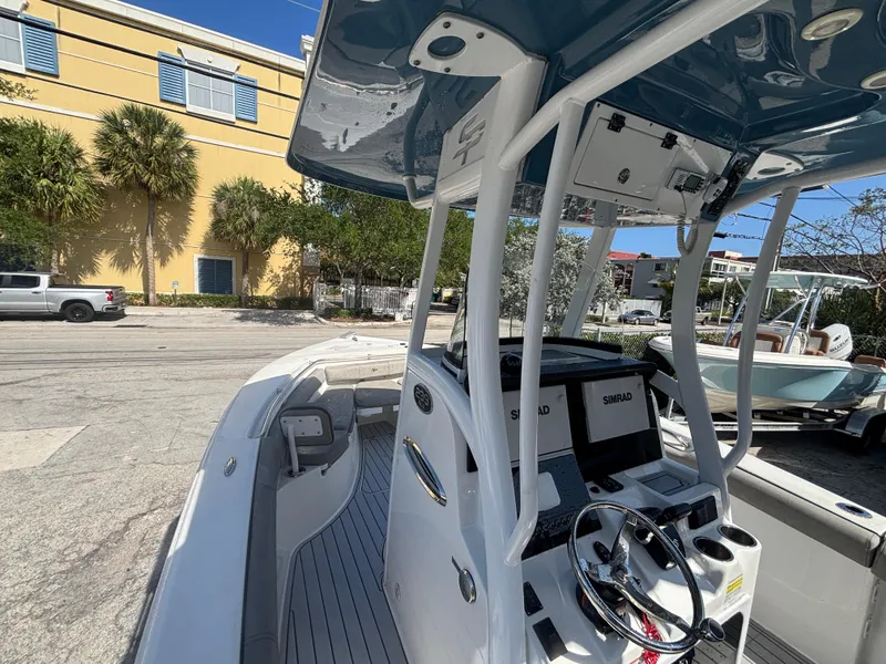 Slide: The Image of 2022 Sea Pro 239 Center Console boat with modern helm and spacious deck. - 12