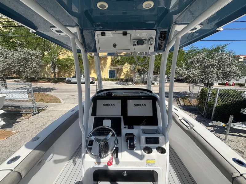 Slide: The Image of 2022 Sea Pro 239 Center Console boat interior with dual Simrad displays. - 13