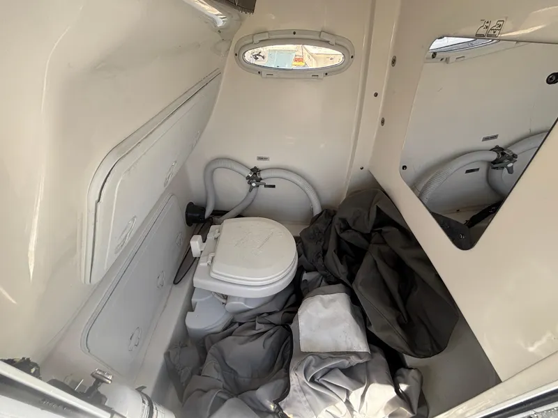 Slide: The Image of Interior of 2022 Sea Pro 239 Center Console boat with compact marine toilet. - 18