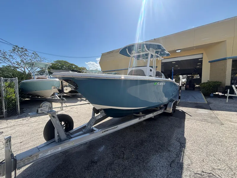 Slide: The Image of 2022 Sea Pro 239 Center Console boat on trailer under sunny sky. - 2