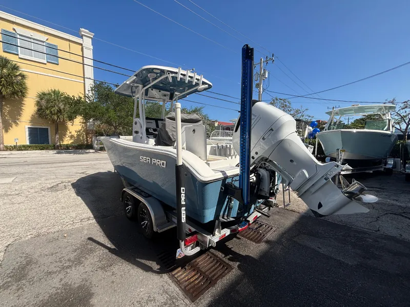 Slide: The Image of 2022 Sea Pro 239 Center Console boat with outboard motor, parked outdoors. - 3