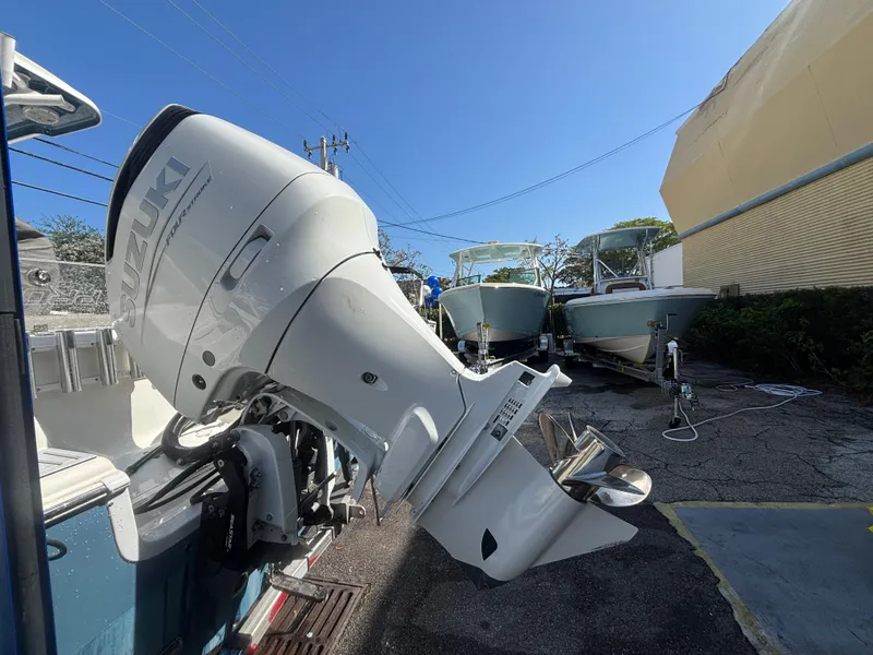 Slide: The Image of 2022 Sea Pro 239 Center Console with Suzuki outboard motor in a boatyard. - 7