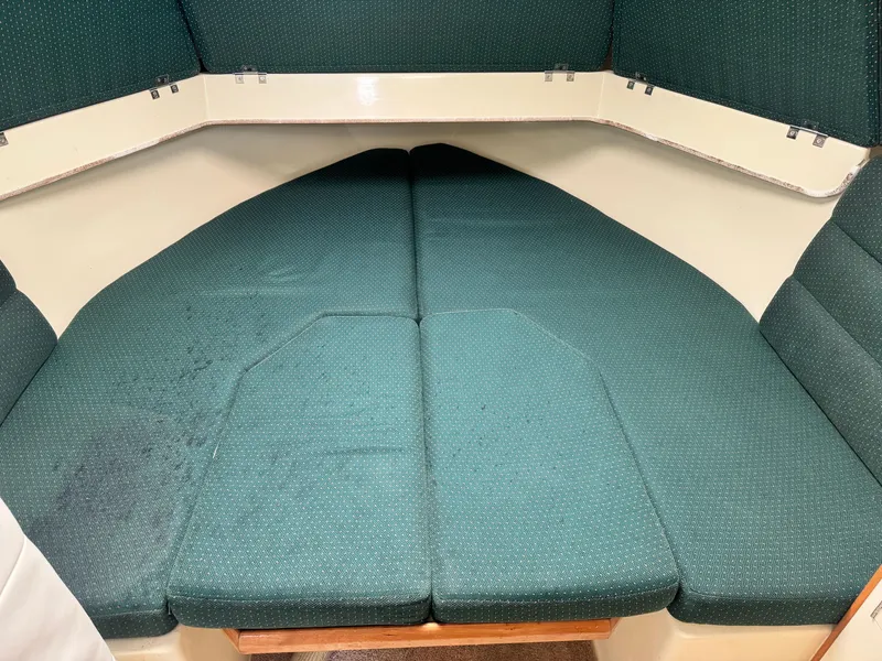 Slide: The Image of 2001 Albin 28 boat interior with green cushioned V-berth. - 14