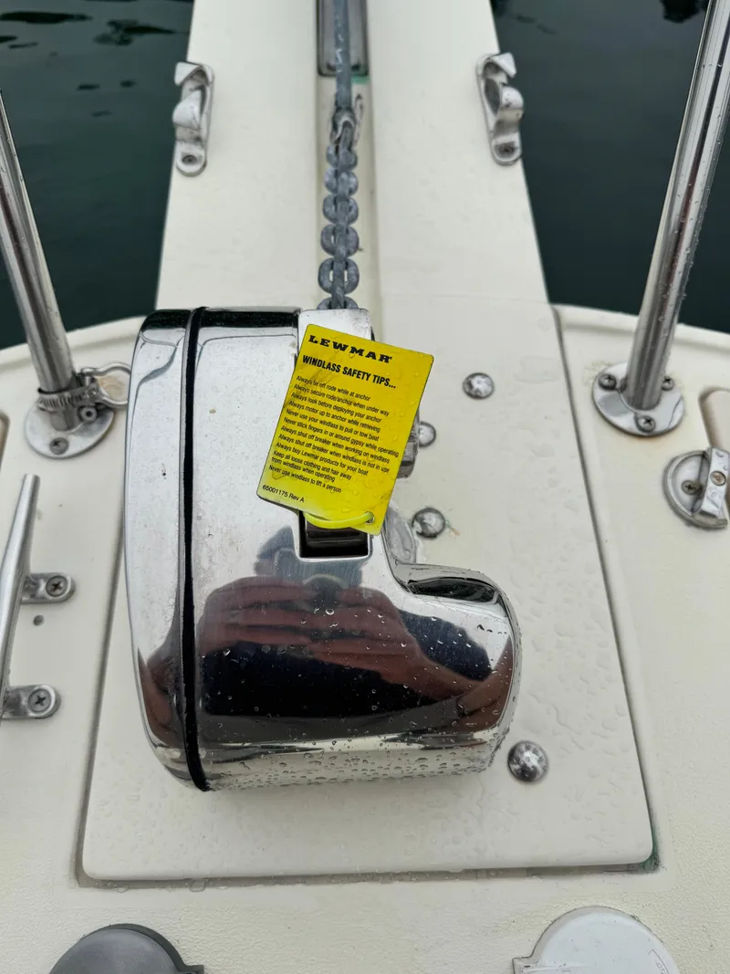 Slide: The Image of Chrome windlass on 2001 Albin 28 boat deck with safety tips label. - 8