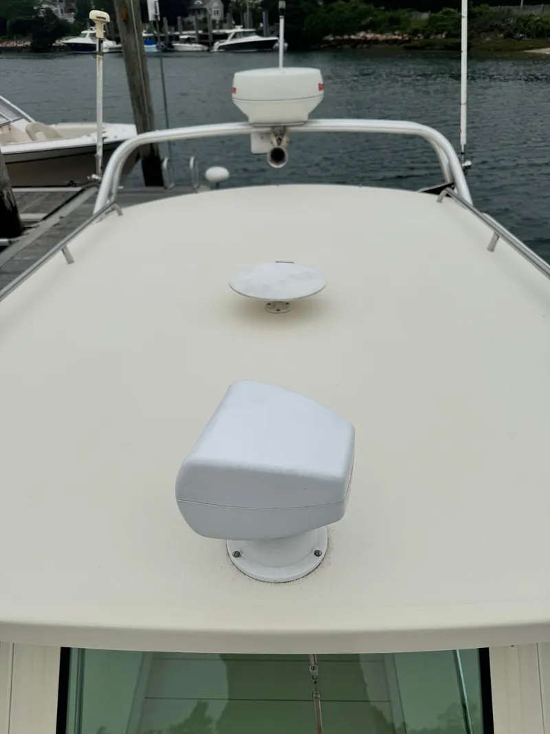 Slide: The Image of 2001 Albin 28 boat deck with radar and navigation equipment, docked by the water. - 9