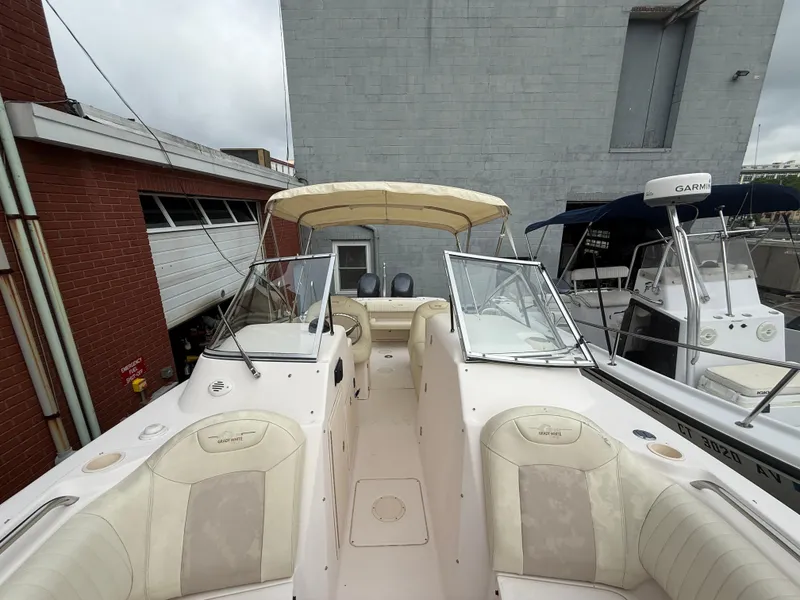 Slide: The Image of 2007 Grady-White Tournament 275 boat with beige seating and canopy, docked near a brick building. - 10