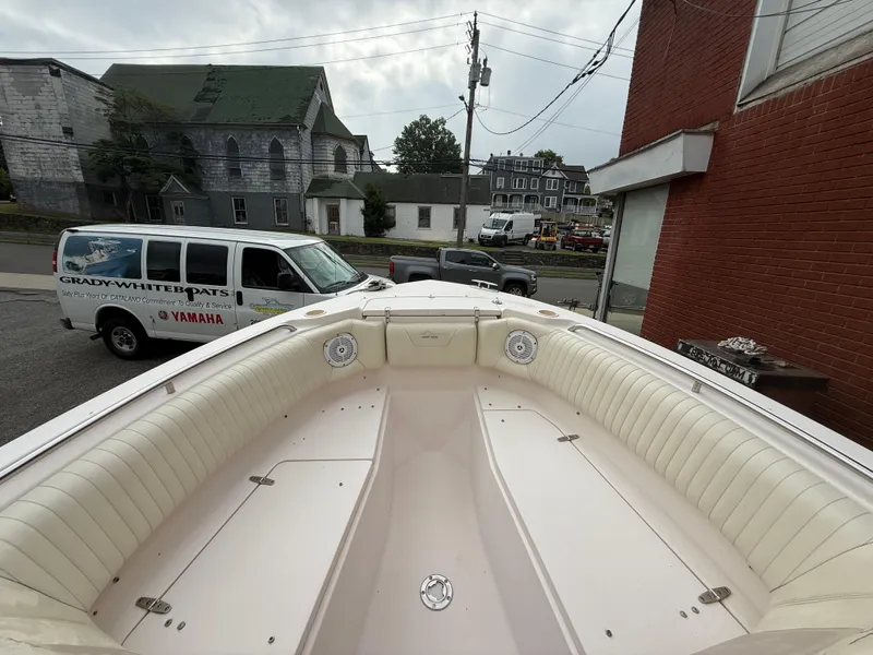 Slide: The Image of 2007 Grady-White Tournament 275 boat with spacious seating, parked near a Grady-White service van. - 11