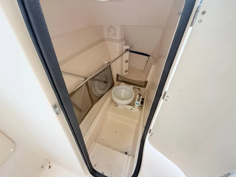 Slide: The Image of 2007 Grady-White Tournament 275 boat bathroom interior with toilet and storage. - 12