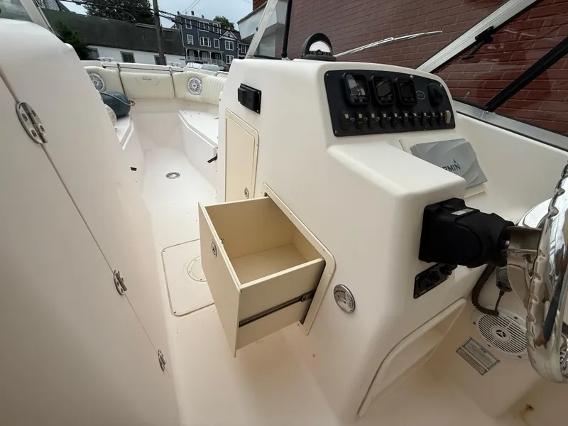 Slide: The Image of 2007 Grady-White Tournament 275 boat interior with open storage compartment and control panel. - 14