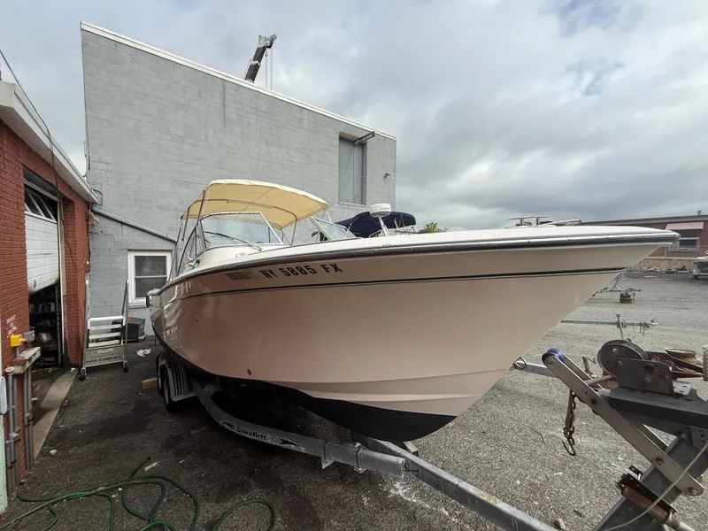 Slide: The Image of 2007 Grady-White Tournament 275 boat on trailer, parked beside a building under cloudy skies. - 16
