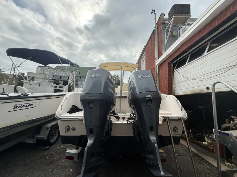 Slide: The Image of 2007 Grady-White Tournament 275 boat with twin Yamaha 150 engines, docked near a Boston Whaler. - 2