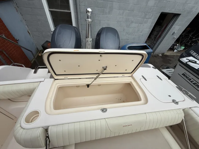 Slide: The Image of 2007 Grady-White Tournament 275 boat with open storage compartment and twin engines. - 5