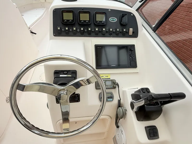 Slide: The Image of 2007 Grady-White Tournament 275 boat dashboard with steering wheel and navigation controls. - 8