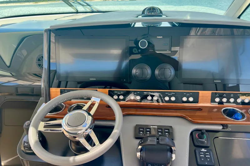 Slide: The Image of Helm of 2020 Tiara Yachts 43 LS with modern navigation displays and controls. - 15