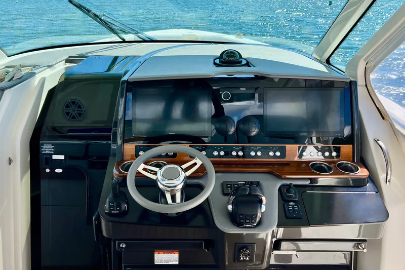 Slide: The Image of Cockpit of 2020 Tiara Yachts 43 LS with modern navigation controls and steering wheel. - 16