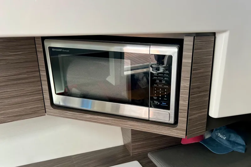 Slide: The Image of Built-in Sharp microwave in 2020 Tiara Yachts 43 LS, modern wood cabinetry. - 18