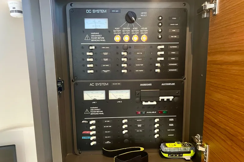 Slide: The Image of Electrical control panel on a 2020 Tiara Yachts 43 LS, featuring DC and AC systems. - 20