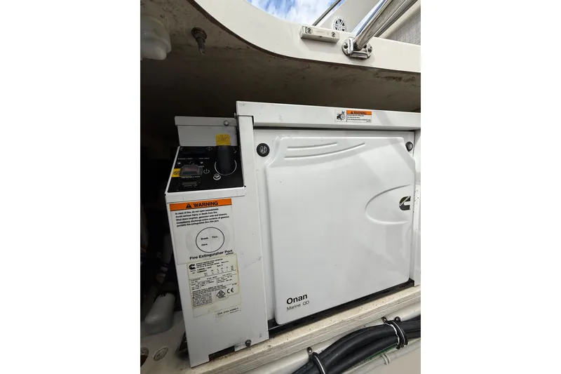 Slide: The Image of Onan Marine QD generator in 2020 Tiara Yachts 43 LS, with control panel and warning labels. - 22