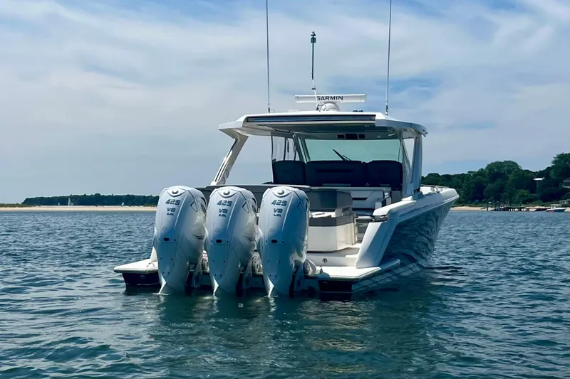 Slide: The Image of 2020 Tiara Yachts 43 LS with triple outboard engines on calm water. - 3