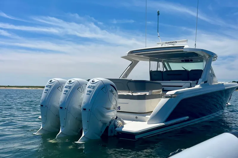 Slide: The Image of 2020 Tiara Yachts 43 LS with triple Yamaha 425 V8 engines on calm water. - 5