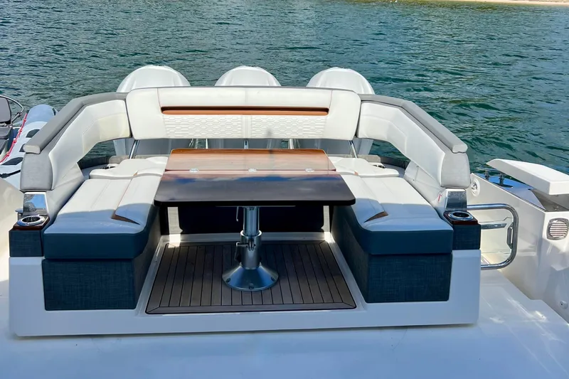 Slide: The Image of 2020 Tiara Yachts 43 LS luxury yacht seating area with table, overlooking serene water. - 6