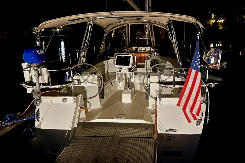 Slide: The Image of 2016 Marlow-Hunter 40 sailboat at night, featuring dual steering wheels and American flag. - 11