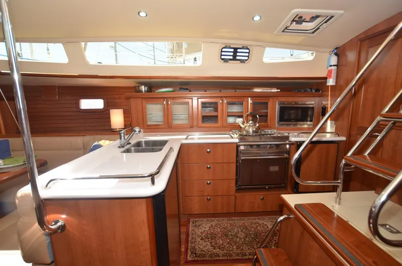 Slide: The Image of Luxurious 2016 Marlow-Hunter 40 yacht interior with modern kitchen and wooden cabinetry. - 14
