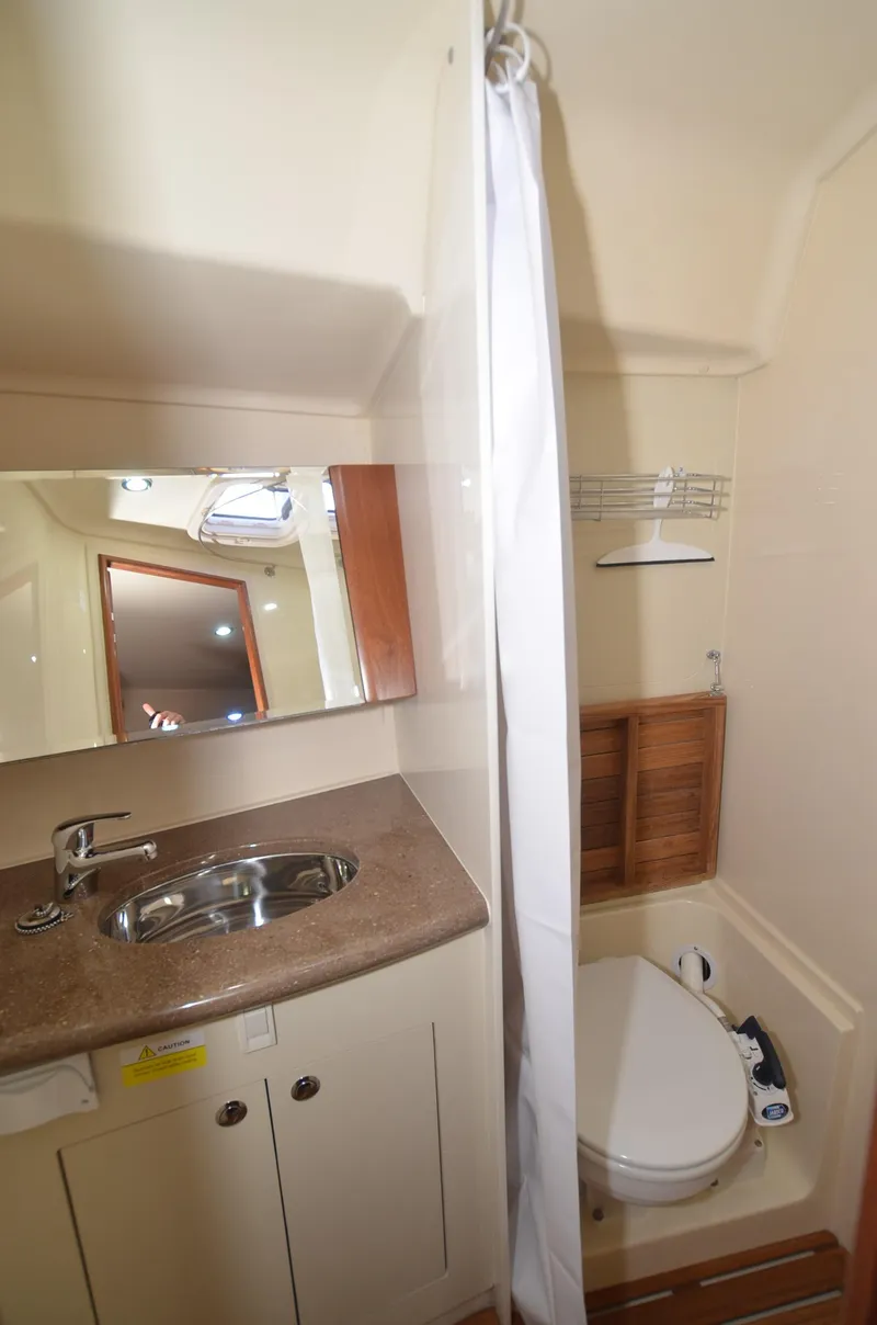 Slide: The Image of 2016 Marlow-Hunter 40 yacht bathroom with sink, mirror, and shower area. - 21