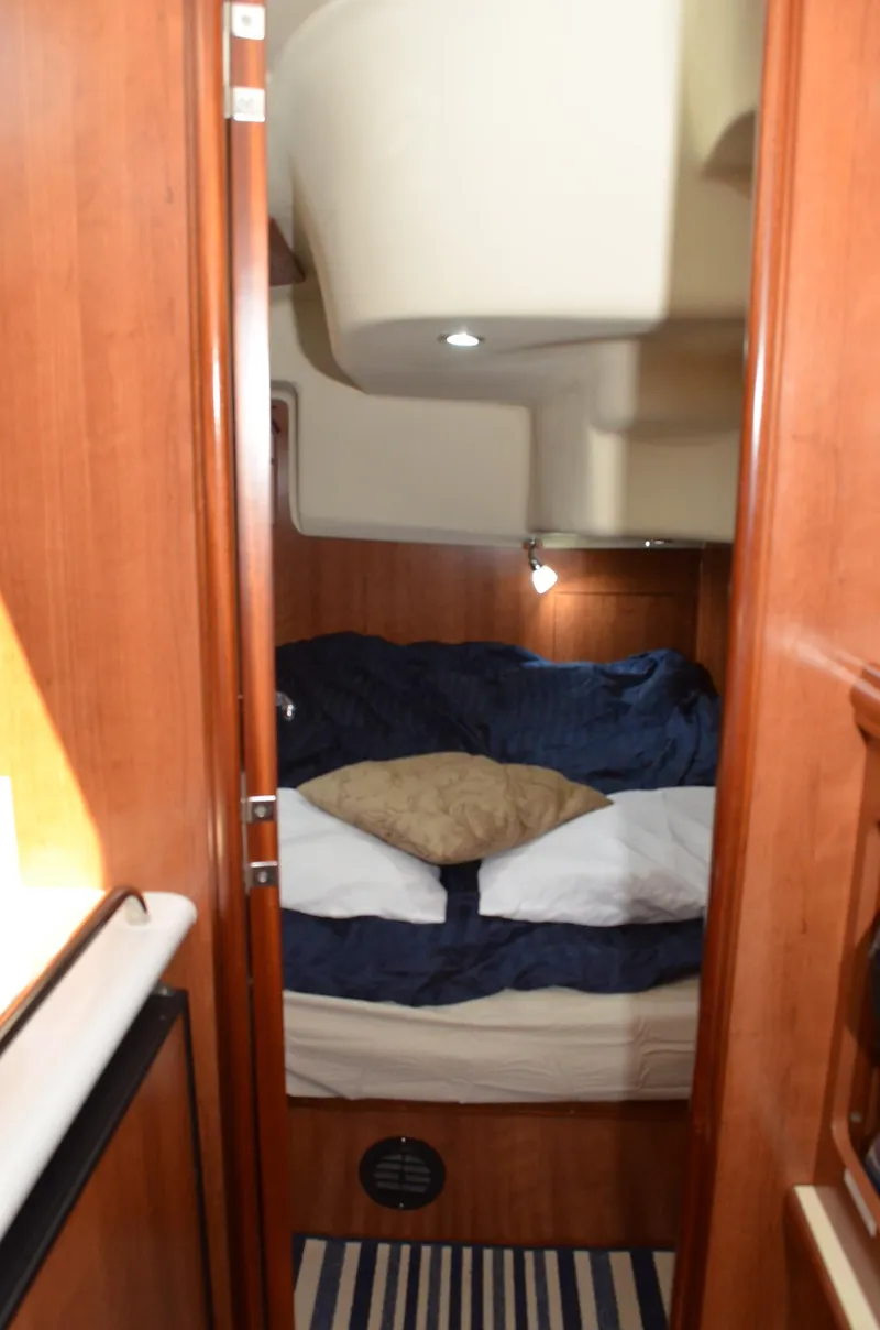 Slide: The Image of 2016 Marlow-Hunter 40 yacht cabin with cozy bedding and wooden interior. - 22