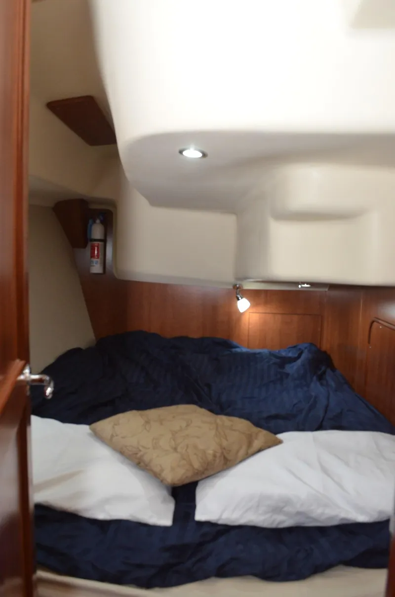 Slide: The Image of Interior cabin of 2016 Marlow-Hunter 40 yacht with cozy bedding and wooden accents. - 23