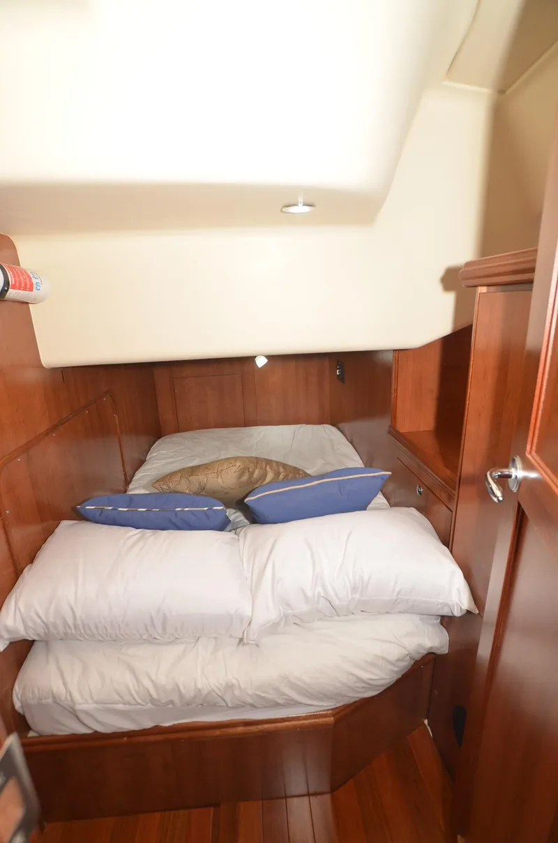 Slide: The Image of 2016 Marlow-Hunter 40 yacht cabin with cozy bed and wooden interior. - 25