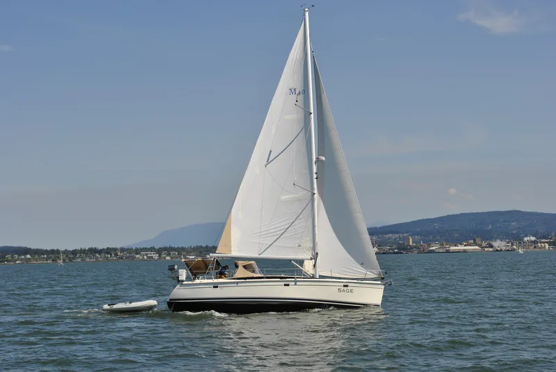 Slide: The Image of 2016 Marlow-Hunter 40 sailboat cruising on calm waters with scenic background. - 5