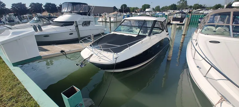 Slide: The Image of 2021 Sea Ray Sundancer 320 docked at a marina, surrounded by other boats. - 0