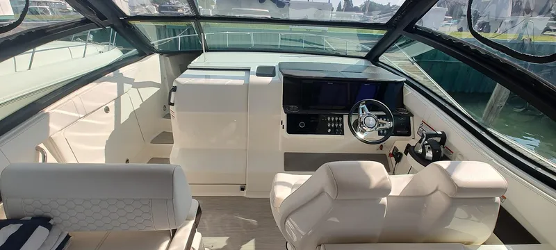 Slide: The Image of 2021 Sea Ray Sundancer 320 helm with modern controls and luxurious seating. - 10