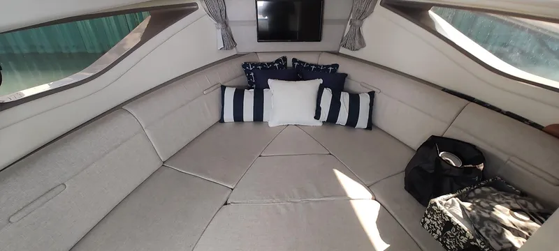 Slide: The Image of Interior of 2021 Sea Ray Sundancer 320 with cozy seating and decorative pillows. - 13