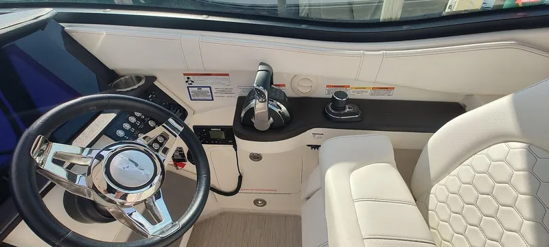 Slide: The Image of Cockpit of 2021 Sea Ray Sundancer 320 with modern steering and controls. - 16