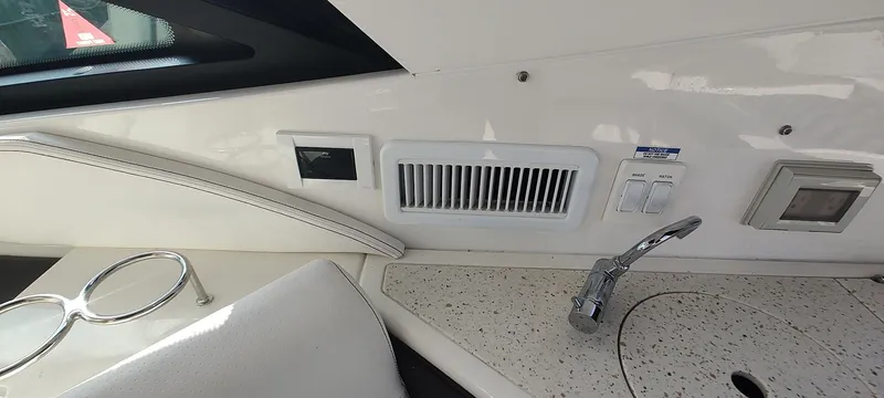 Slide: The Image of Interior view of 2021 Sea Ray Sundancer 320 yacht, featuring a sink and control panel. - 17