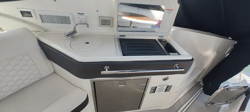 Slide: The Image of 2021 Sea Ray Sundancer 320 yacht kitchenette with sink, grill, and storage. - 18