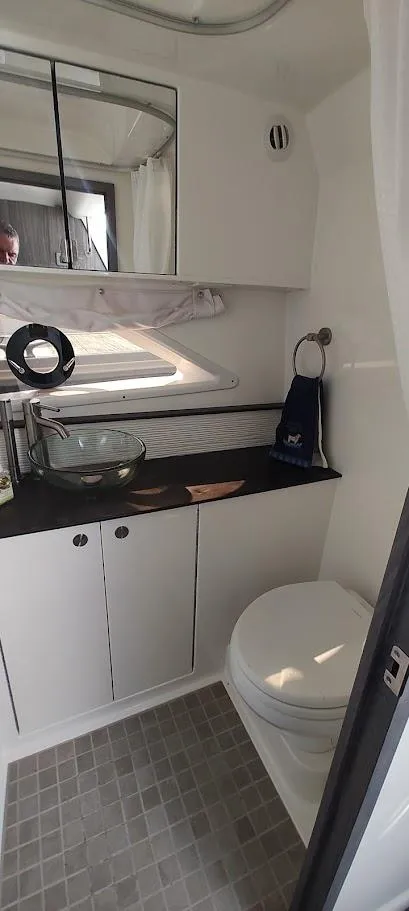 Slide: The Image of 2021 Sea Ray Sundancer 320 bathroom with modern fixtures and compact design. - 19