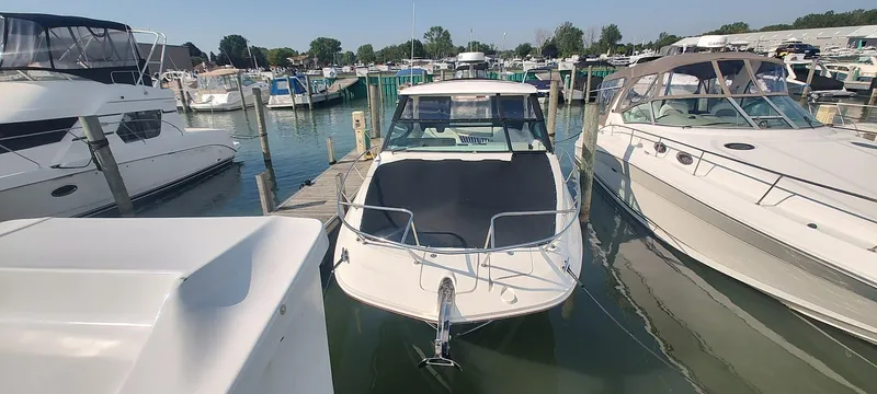 Slide: The Image of 2021 Sea Ray Sundancer 320 docked at a marina, surrounded by other boats. - 2