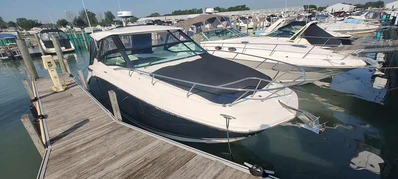 Slide: The Image of 2021 Sea Ray Sundancer 320 docked at marina, surrounded by other boats. - 3
