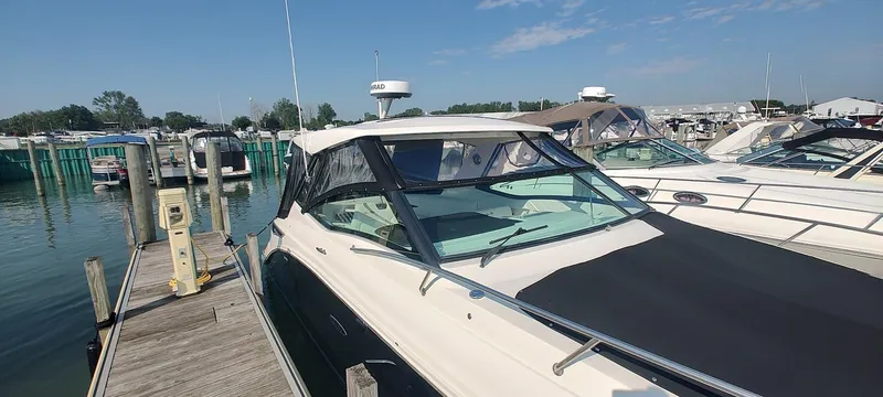 Slide: The Image of 2021 Sea Ray Sundancer 320 docked at marina under clear blue sky. - 5