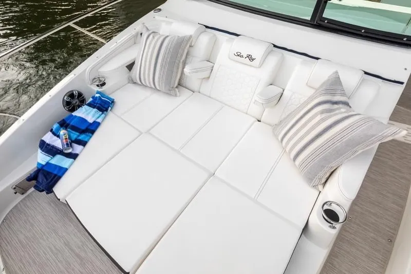 Slide: The Image of Manufacturer Provided Image: 2021 Sea Ray Sundancer 320 boat lounge area with cushions and striped pillows. - 9
