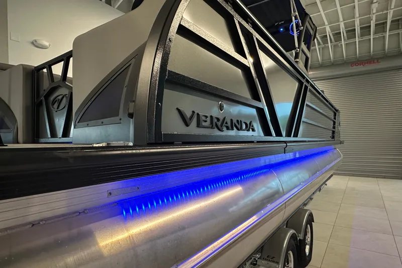 Slide: The Image of 2025 Veranda VX 27 DCRC pontoon boat with sleek design and blue LED lighting. - 18