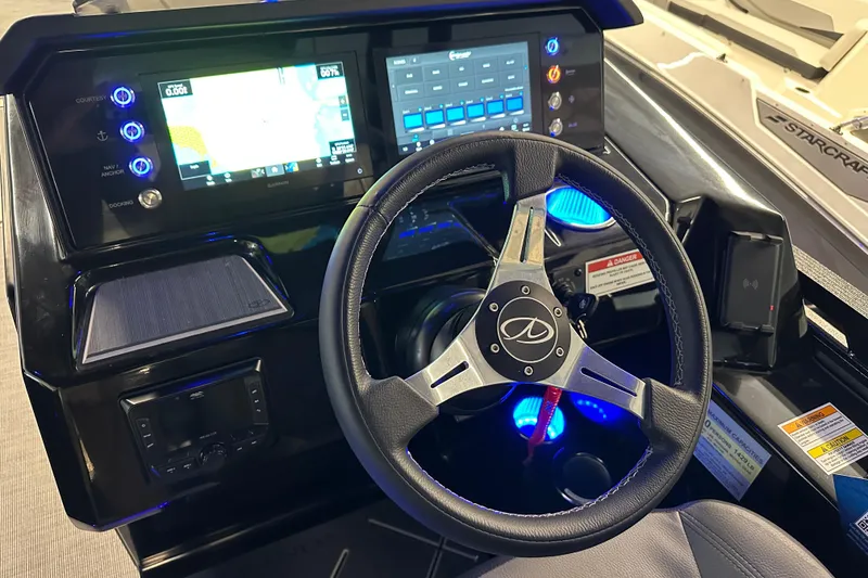 Slide: The Image of 2025 Veranda VX 27 DCRC boat dashboard with steering wheel and digital controls. - 8